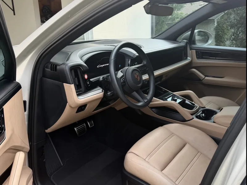 Porsche SUV interior after detailing: clean tan leather seats, dashboard and door sills