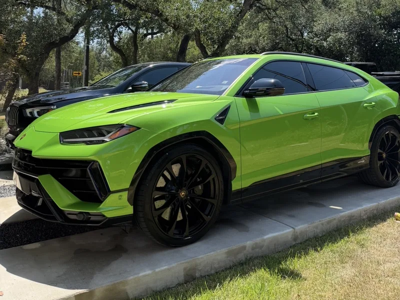 Freshly detailed lime green SUV with glossy paint parked on a concrete driveway